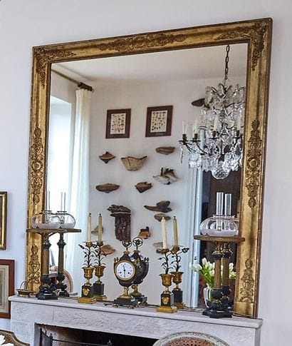 Fireplace mirror, the gilded wooden surround...