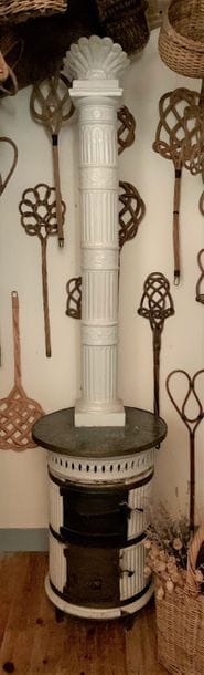 Small white glazed earthenware stove, cylindrical...