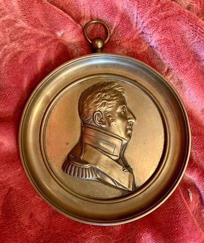 Round bronze medallion of a man in profile...
