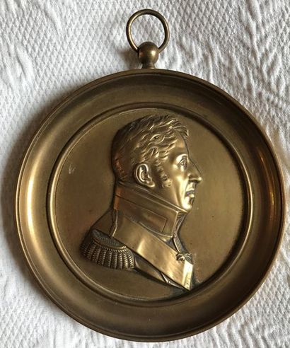 Round bronze medallion of a man in profile...