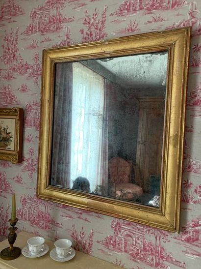 Mirror with a wide gilded wood moulding slightly...