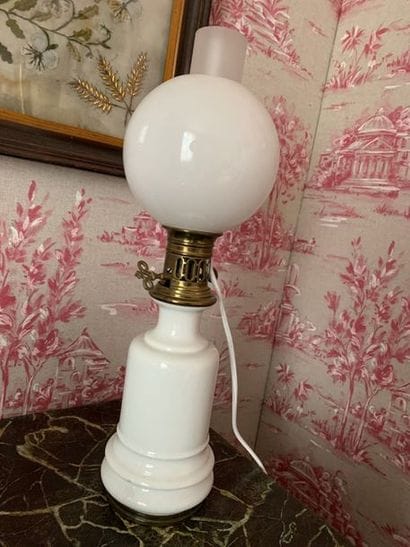 Old oil lamp in white porcelain, the frame...