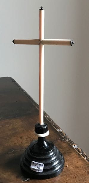 Ivory cross, the base in blackened turned...