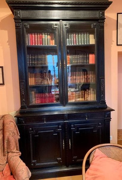 Blackened wooden bookcase decorated with...