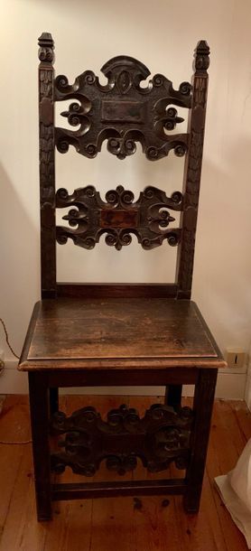Fruitwood chair with dark patina. The sculpted...
