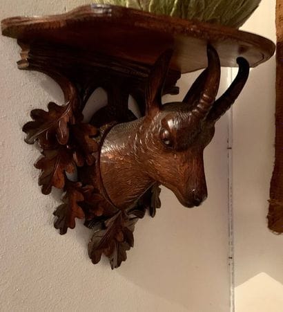 Two wall consoles in natural wood, one decorated...