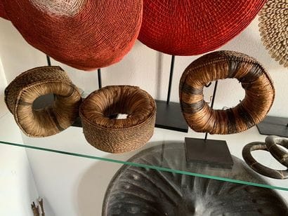 Three braided straw and fibre bracelets with...