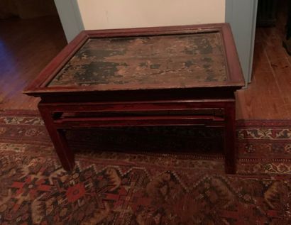 Coffee table in red lacquered wood, the top...