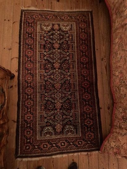 Small wool oriental rug decorated with five...