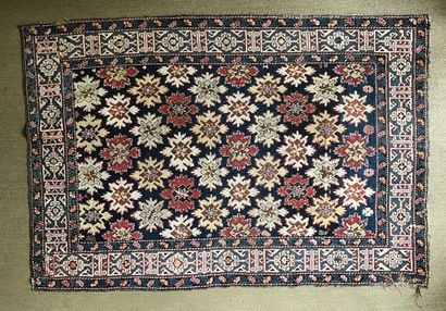 Caucasian carpet with stylized star motifs...