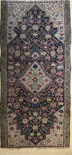Small wool oriental rug decorated with a...