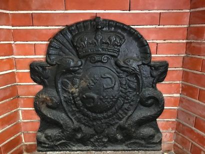 Cast iron fireback with a cut-out shape,...