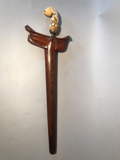 Kriss, the carved ivory grip of a half-man...