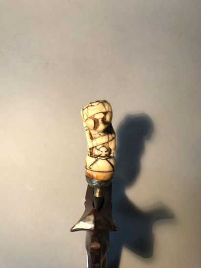 Kriss, the carved ivory grip of a half-man...