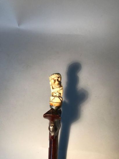 Kriss, the carved ivory grip of a half-man...