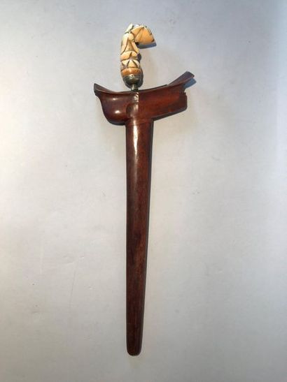 Kriss, the carved ivory grip of a half-man...