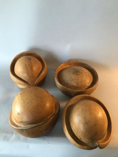 Four wooden hat forms.