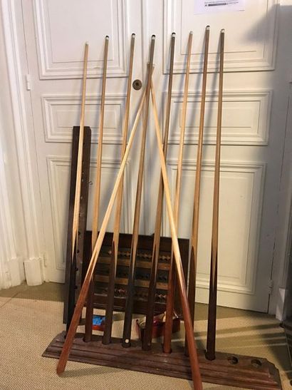 Ten pool cues.
Three ivory balls, a two-piece...