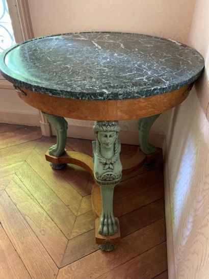 Elm burr veneer pedestal table rests on three...