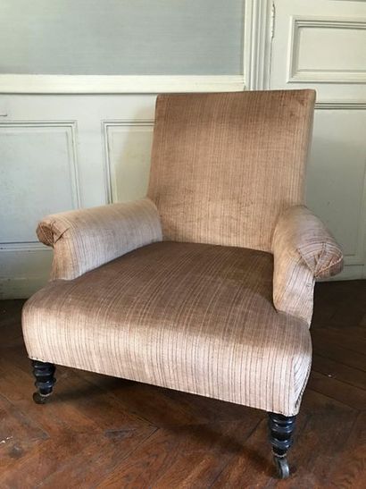 Two low armchairs of different models, the...