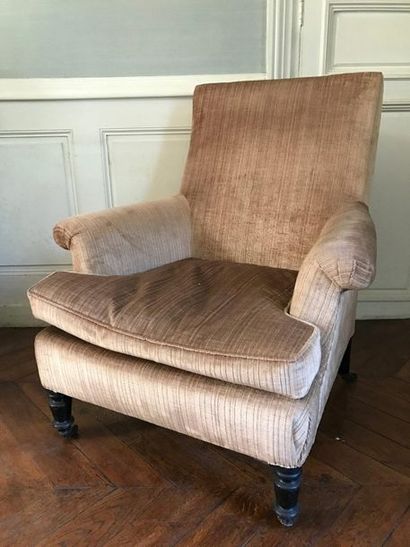 Two low armchairs of different models, the...