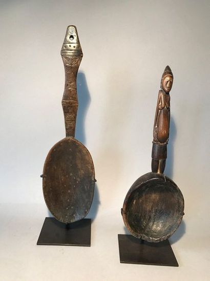 Two carved wooden spoons, the handle of one...
