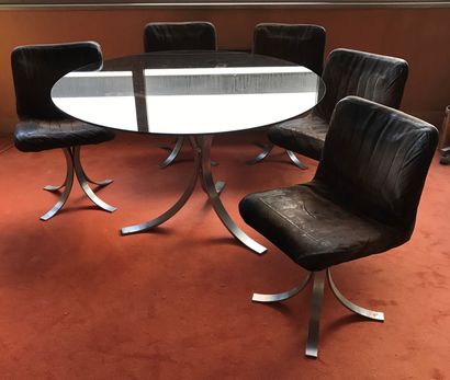 Table, the round top in smoked glass, the...