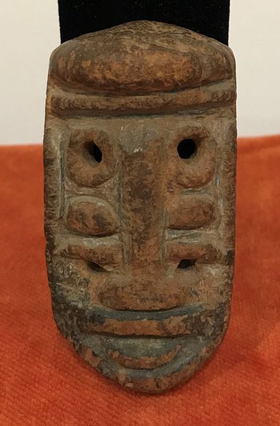 Carved wooden mask with multiple pairs of...