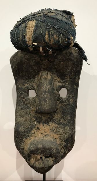 Carved wooden mask with sacrificial patina...