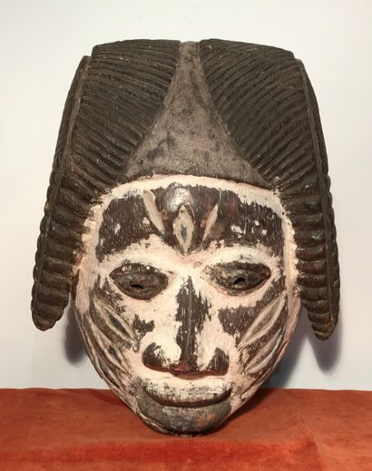 Wooden Guélédé mask with a white patina,...