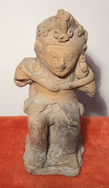 Statue of a seated character in terracotta....