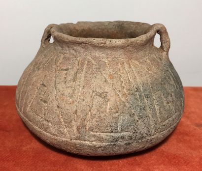 Small incised terracotta pot with geometric...