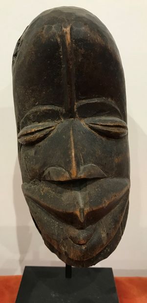 Wooden mask with coffee bean eyes. 
GUERE...