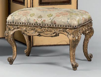A giltwood stool with carved plumes and foliage...