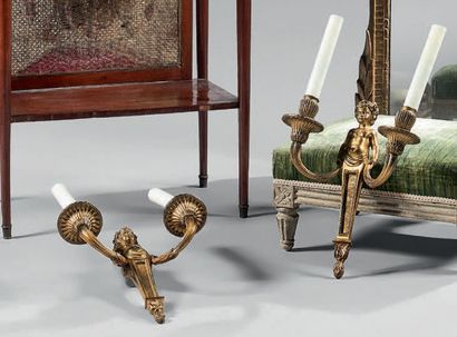 A pair of gilt bronze wall sconces with a...