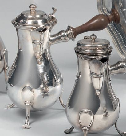 A silver tripod coffee pot, of baluster form,...