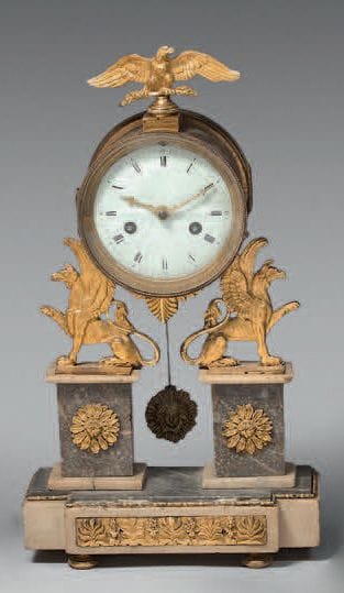 A small clock in grey and white marble and...