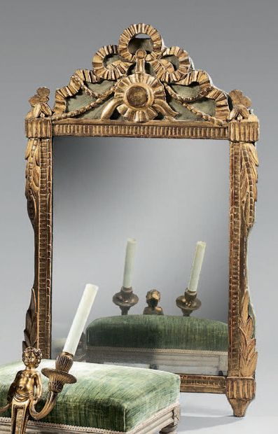 A giltwood and green lacquered mirror carved...