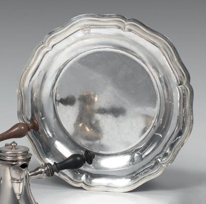Large round and hollow silver dish with contours...