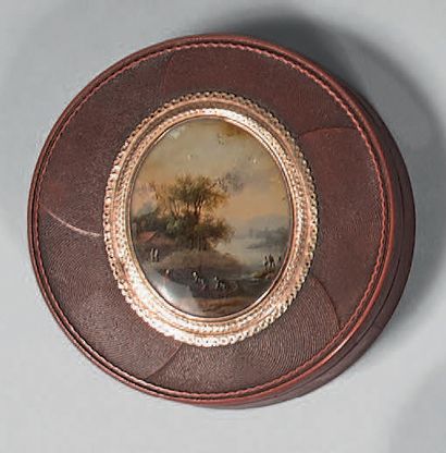 A red lacquer box with a rotating decoration,...