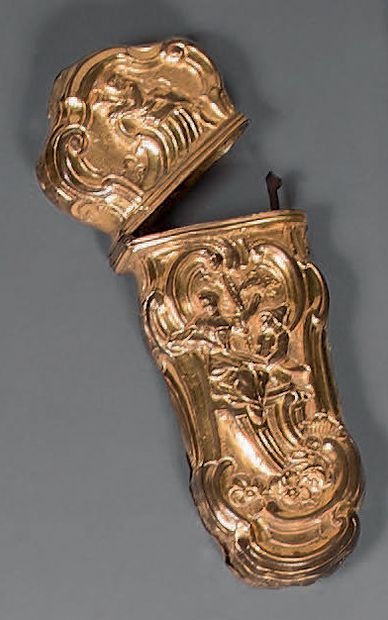 A pompom-shaped case with chased scenes of...