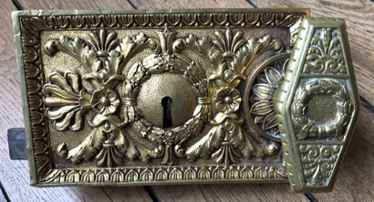 Important gilt bronze lock, chased with laurel...