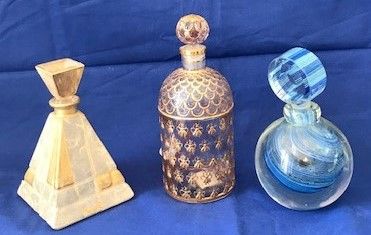 Set of three glass bottles, including a Guerlain,...
