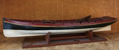 Painted wood reduction of a rowboat.