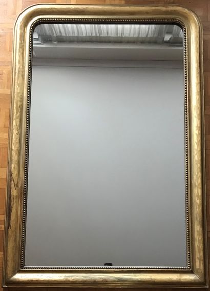 A giltwood mirror with a foliage frieze and...