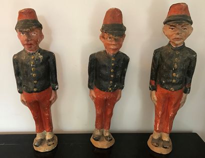 Suite of three statuettes of games of chamboule-tout,...