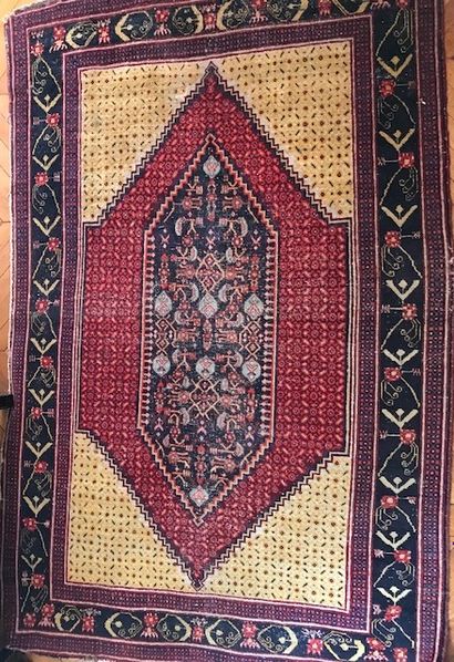 Oriental wool carpet. Decorated in the center...