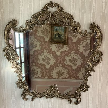 A cast bronze mirror, the contoured frame...