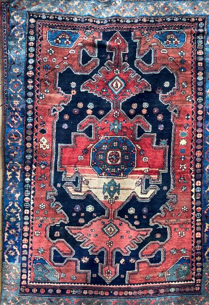 Oriental wool carpet. Decorated with a central...