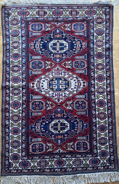Oriental wool carpet decorated with a lozenge...